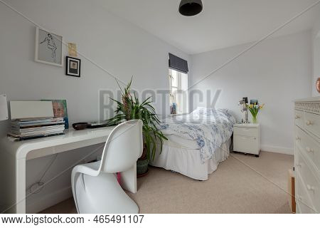 Fen Ditton, England - Jan 10 2019:  Furnished Bedroom With Single Bed And Desk With Magazines