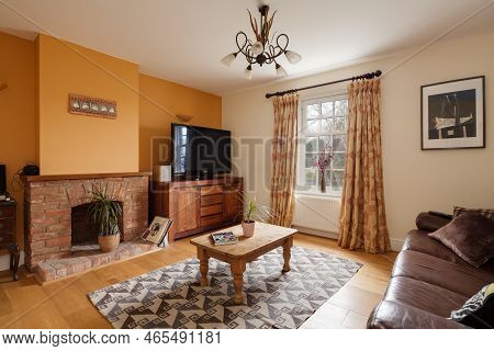 Fen Ditton, England - Jan 10 2019: Modern Luxury Furnished House Living Room With Orange Painted Fea