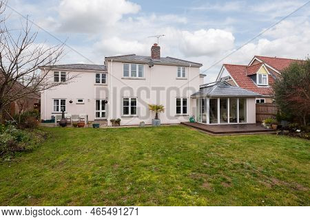 Fen Ditton, England - Jan 10 2019: Detached House Rear Elevation And Garden With Lawn And Decking