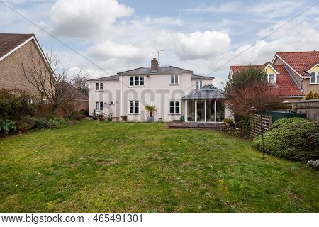 Fen Ditton, England - Jan 10 2019: Detached House Rear Elevation And Garden With Lawn And Decking