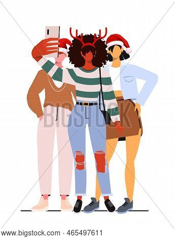 Young Modern Girls And A Guy In Casual Clothes And New Year Hats Take A Front Camera Selfie. A Group