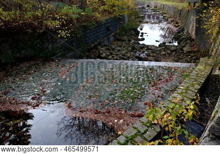 Trading In River Boulders For Decorative And Building Purposes. A Brewer On A Pile Of Round And Roun