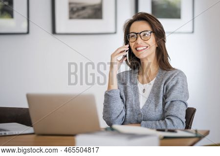 Attractive Woman Wearing Eyewear And Casual Clothes While Working From Home. Business Woman Using La