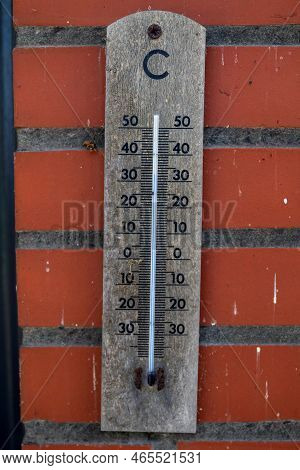 A Portrait Of A Wooden Mercury Thermometer Indicating The Outdoor Temperature In Degrees Celcius And