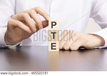 Pte, Pearson Tests Of English Text On Cube Blocks In Businessman Hands, Man In White Shirt