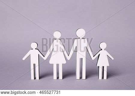 Figures Of Family Stainding On Lilac Background. Insurance Concept