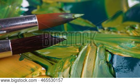 Brush On Artist's Palette With Mixed Paints, Closeup