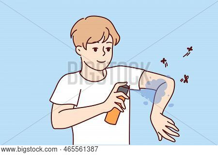 Smiling Man Applying Anti-mosquito Spray On Arms. Guy Use Insect Repellent Keep Bugs Away Outdoors. 