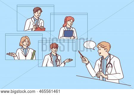 Male Doctor Talk On Video Call With Colleagues Consulting. Gp Have Online Consultation With Coworker