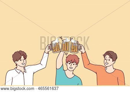 Smiling Young Men Clinking Glasses Drinking Beer Together. Happy Guys Cheers Enjoy Party Have Fun. F