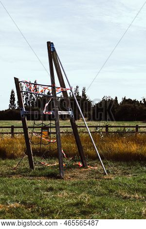 Hazard Tape Covering Wooden Playground In Field