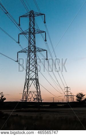 Summer Sunset With Leading Line Of Electricity Power Lines And Masts
