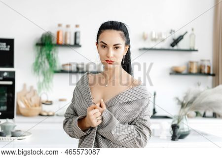 A Young Woman In The Kitchen In A Jacket. Stress-free Concept. Slow Living. Enjoying The Little Thin