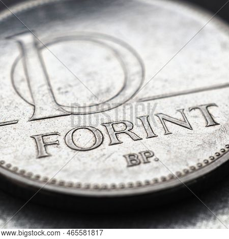 Hungarian Coin Of 10 Forints Lies On Textured Surface Close Up. Money Of Hungary. News About Economy