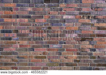 Background, Brick Wall Made Old German Red Burnt Brick With Traces Bullets And Shrapnel After World 