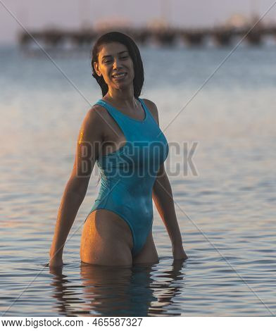 Young Woman In The Water Of The Caribbean Sea Of The Mexican Mayan Riviera At Sunrise.