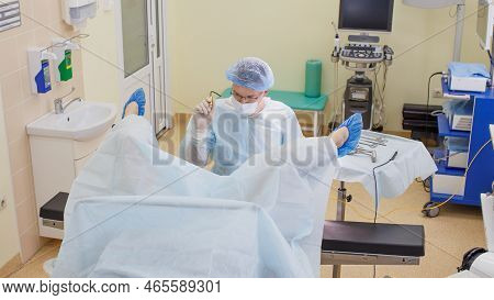 The Proctologist Examines The Patient On A Proctological Chair In The Office Using Laser Equipment.