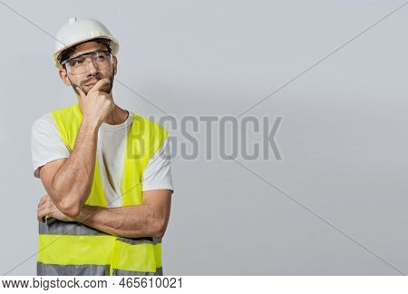 Pensive Builder Man With Hand On Chin, Portrait Of Young Builder Thinking With Hand On Chin Isolated