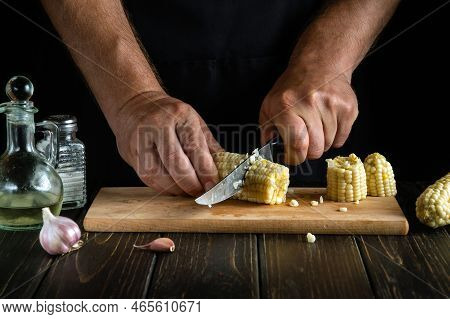 Professional Chef Cuts The Boiled Maize With A Knife. Corn Is An Excellent Dietary Breakfast Or Lunc