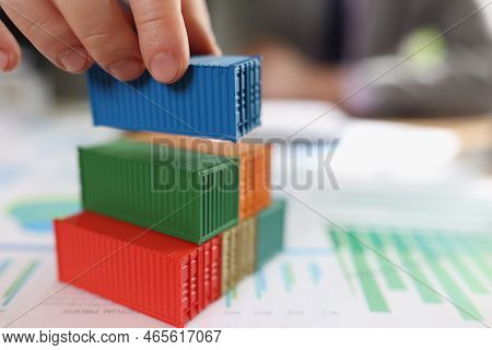 Stack Of Cargo Containers On Financial Report Papers And Blurred Business Man. Logistics, Shipping, 