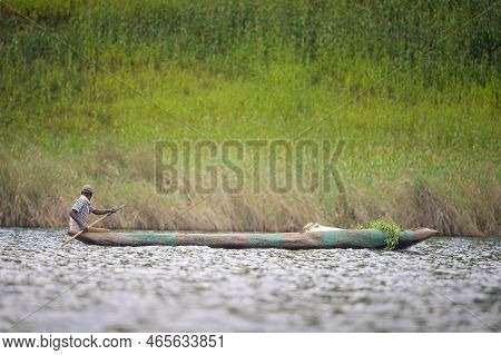 Kabale, Uganda - June 12, 2022: Man In A Dugout Canoe On Lake Bunyonyi (uganda), Sunny Day In Summer