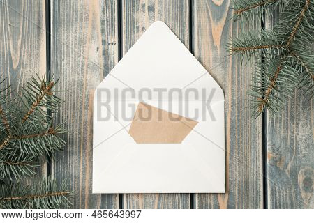 White Open Envelope On Gray Wooden Background With Blank Kraft Paper Greeting Card With Branches Of 