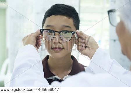 Smart Young Buy Student In Striped Polo T-shirt Happy Trying Out, Testing, And Choosing New Eyeglass