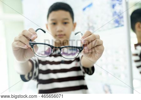 Smart Young Buy Student In Striped Polo T-shirt Happy Trying Out, Testing, And Choosing New Eyeglass