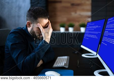 Worried Man At Computer With System Failure Screen At The Workplace