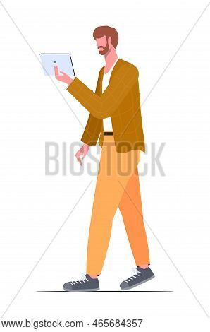 Young Guy In Modern Casual Clothes With A Tablet In His Hand. Vector Illustration In A Flat Style.