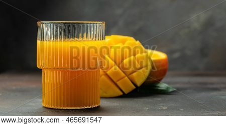 Mango Juice With Fresh Tropical Fruit On A Dark Background. Long Banner Format.