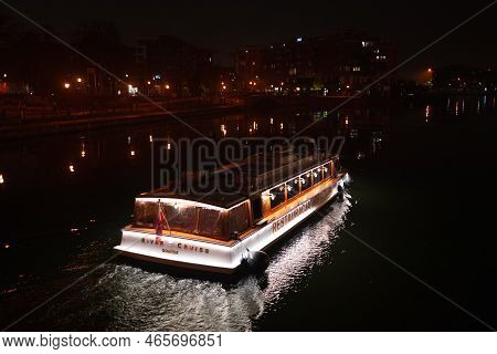 Gdansk, Poland - October 31, 2022: Night View Of Gdansk Poland With A Small Cruise Boat. Night Trip
