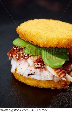 Pan-asian Cuisine Concept. Japanese Sushi Burger Made From Rice Bread, Crab Meat, Avokado And Wasabi