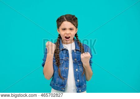 Lost Her Temper. Bad Girl. Angry Kid Shake Fists Blue Background. Bad Behavior. Aggression And Negat