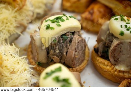 French Mini Quiche Pie With Goat Cheese And Traditional French Sausage Andouillette From Troyes In B