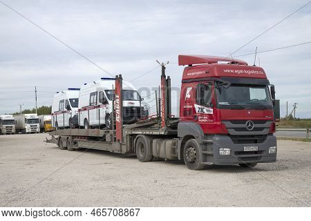 Volgograd Region, Russia - September 18, 2021: Mercedes-benz Axor Car Transporter With Two New Ambul