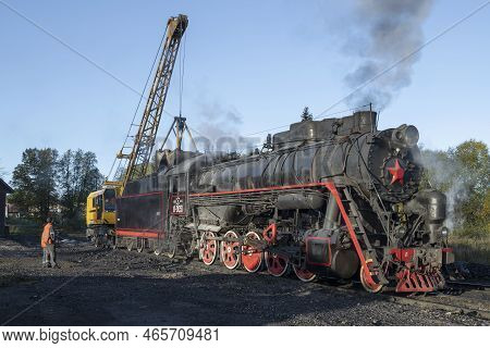Sortavala, Russia - October 09, 2022: Railway Crane Loading Old Steam Locomotive With Coal On The So