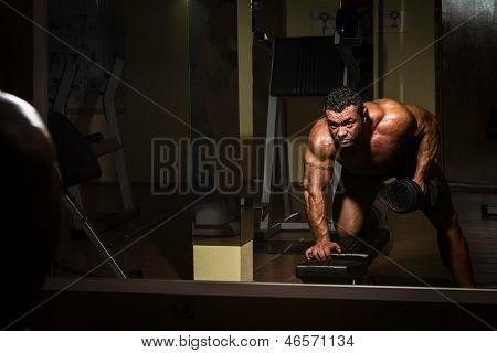 Male Bodybuilder Doing Heavy Weight Exercise For Back