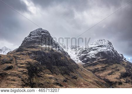 Epic Winter Landscape Image Of Snowcapped Three Sisters Mountain Range In Glencoe Scottish Highands 