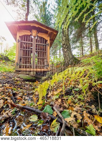 Renewal Old Wooden Christian Well And Spring Water Hidden In The Autumn Lipova Chateau Park, A Woode