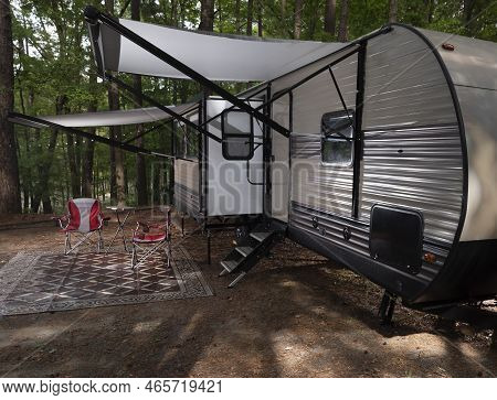 Two Awnings Out In A Camping Trailer Campsite