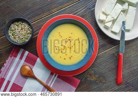 Breakfast. Cornmeal Porridge In Bowl, Different Seeds And White Cheese