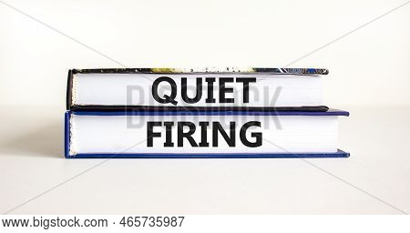 Quiet Firing Symbol. Concept Words Quiet Firing On Books. Beautiful White Table White Background. Bu