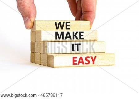 We Make It Easy Symbol. Concept Words We Make It Easy On Wooden Cubes. Beautiful White Table White B