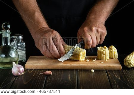 Professional Chef Cuts The Boiled Maize With A Knife. Corn Is An Excellent Dietary Breakfast Or Lunc