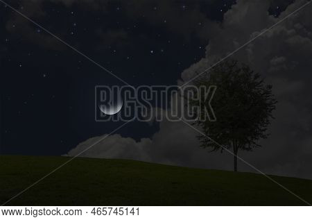 Beautiful Cresent Moon In Blue Sky Behind Grass Hill And Tree