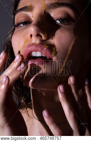 Portrait Of Girl With A Honey Facialmask Closeup. Beautiful Woman With Honey On Her Face. Healthy Pe