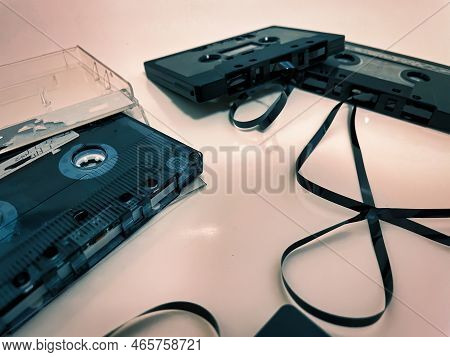 Different Cassette Tapes With Broken Tape Laying Around Ready To Rewound