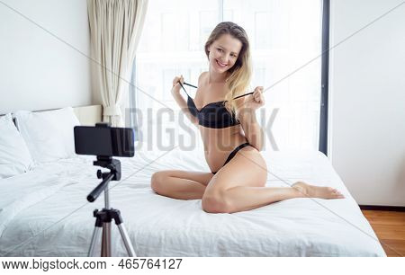 Young Sexy Woman Posing In Front Of Camera And Working As Webcam Model