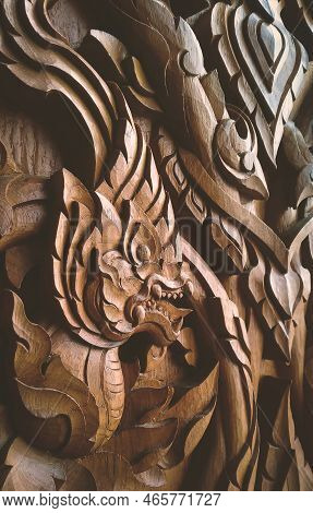 Side View Of Wood Craving Kranok With Serpent Traditional Pattern On Teak Wooden Door Background In 